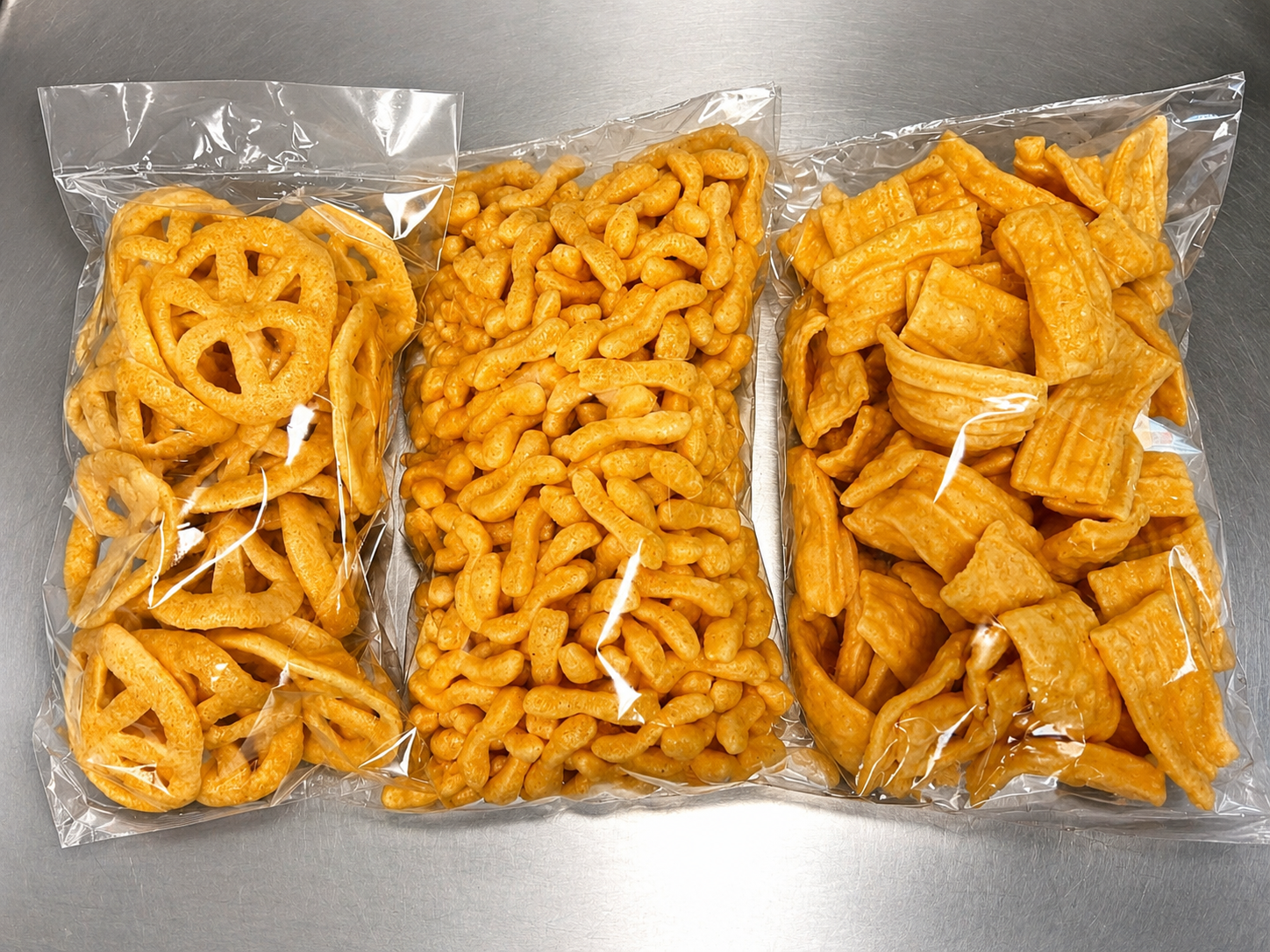 Three sealed bags of crispy chili-dusted chicharrones