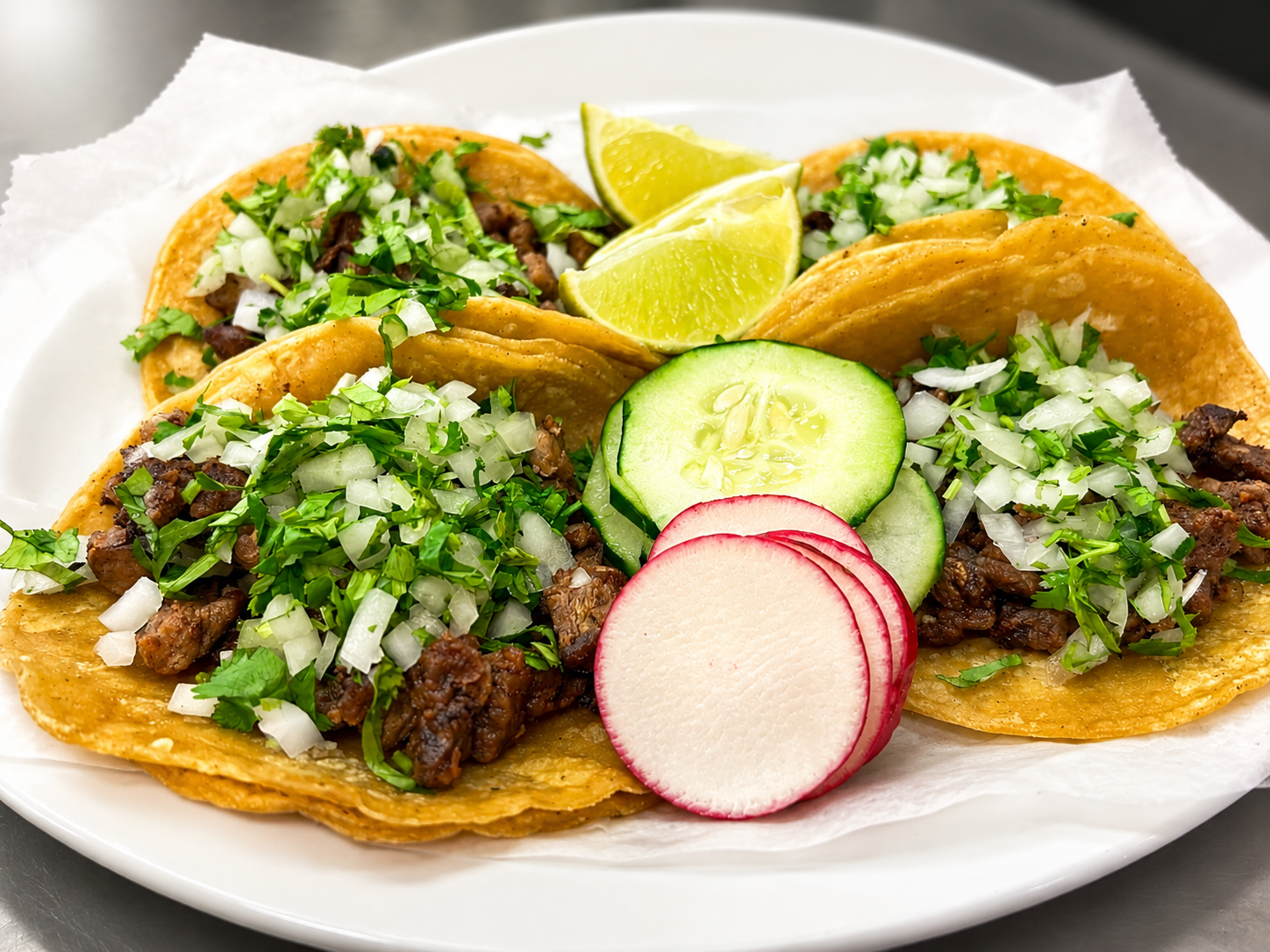Street-style tacos with seasoned meat, onion, and cilantro